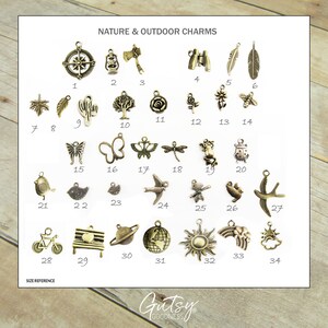 May include: A collection of 34 nature and outdoor themed charms. The charms are made of metal and have a variety of designs, including a compass, a lantern, an axe, binoculars, a feather, a cactus, a tree, a rose, a sunflower, a bee, a butterfly, a dragonfly, a frog, a ladybug, a bird, a bicycle, a bench with a heart, a planet, a globe, a sun, a rainbow, and a cloud.