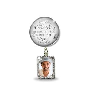 May include: A silver charm with a photo frame and a round charm with the text "On your wedding day, my heart is there... I love you my son, I am near".