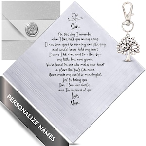 May include: A white handkerchief with a printed poem to a son from his mother. The poem is in black script. A silver tree charm hangs from a clip. An envelope with a floral wax seal is in the background.