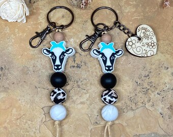 Llavero de silicona de vaca lechera: lazo turquesa con detalles de madera