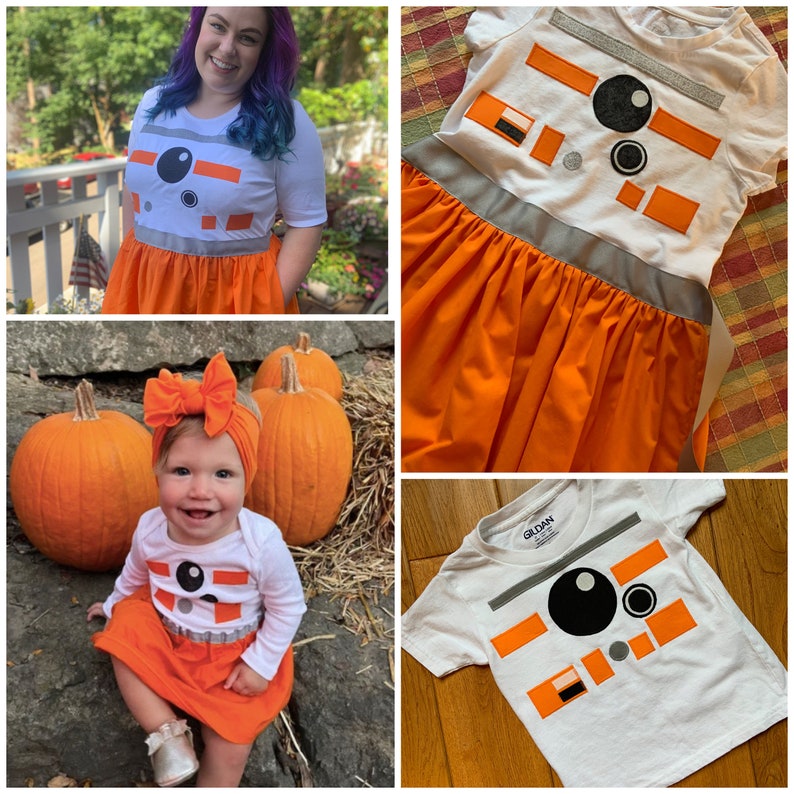 May include: Three white t-shirts with an orange and white BB-8 design. The shirts are on a white background. The shirts are for children and adults.