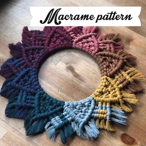 May include: A colourful macrame wall hanging with a circular shape and a fringe border. The hanging is made with a variety of colours, including burgundy, pink, brown, yellow, blue, and green.