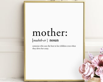 May include: A black and white printable wall art print with a gold frame. The print features the definition of the word "mother" with the phonetic pronunciation and the definition: "someone who sees the best in her children even when they drive her crazy."