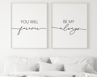 May include: Two black and white framed prints with the text "You will forever" and "Be my always" in a cursive font. The prints are hanging on a white wall above a white bed with white bedding.