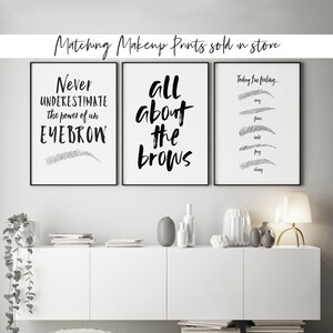 May include: Three black and white framed prints with eyebrow-themed quotes and illustrations. The first print says "Never underestimate the power of an eyebrow" with a single eyebrow illustration. The second print says "All about the brows". The third print says "Today I'm feeling..." with five eyebrow illustrations labeled "stay", "fierce", "bold", "fray", and "classy".