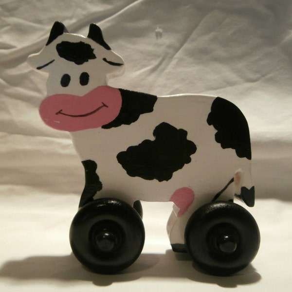 wooden toy cow,on wheels, farm animal, wood toys,todler, roll on the floor, push pull.