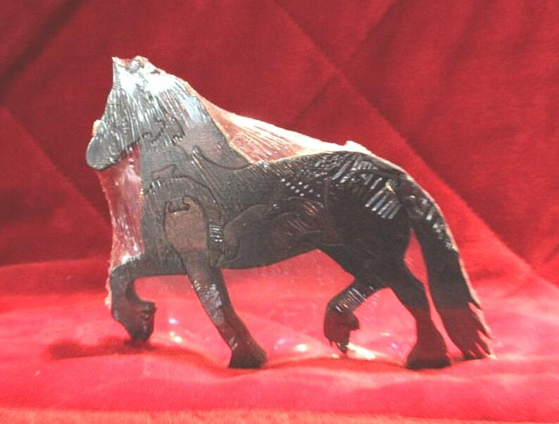 May include: A dark brown wooden horse figurine crafted from interlocking puzzle pieces. The horse is depicted in a standing position with a textured mane and tail, showing visible seams where the individual wooden components fit together.