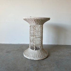May include: White wicker side table with a round top and a woven base.