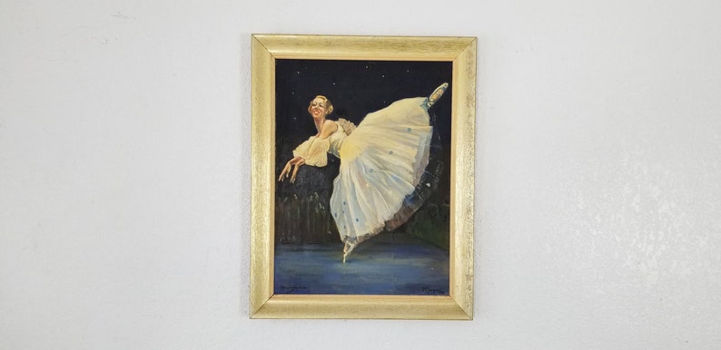 May include: A framed painting of a ballerina in a white tutu, dancing against a dark blue background with stars. The ballerina is in mid-air, with her leg extended and her arms outstretched.