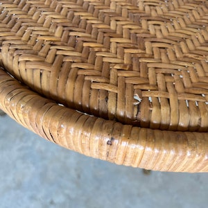 May include: Close-up of a round woven wicker table top with a natural brown color.