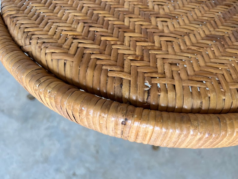 May include: Close-up of a round woven wicker table top with a natural brown color.