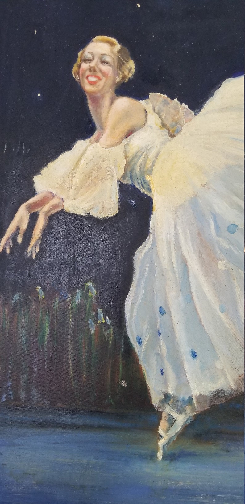 May include: A woman in a white dress with blue accents is posed in a ballet position. She is smiling and looking to the left. The background is dark blue with white stars.