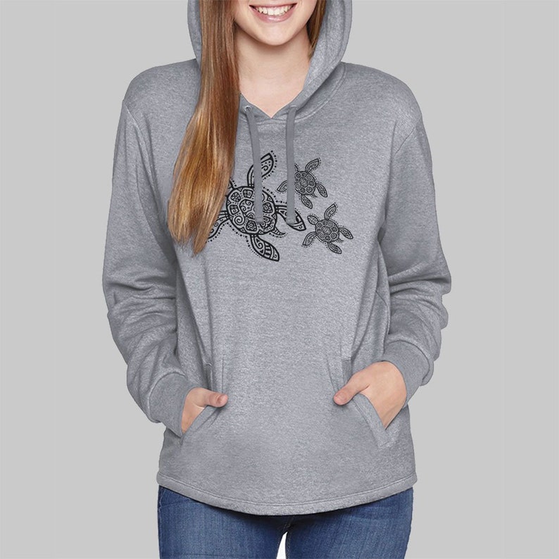 May include: A gray hooded sweatshirt with a kangaroo pocket and a drawstring hood. The sweatshirt features a black graphic of three turtles. The turtles are in various sizes and have detailed patterns on their shells.
