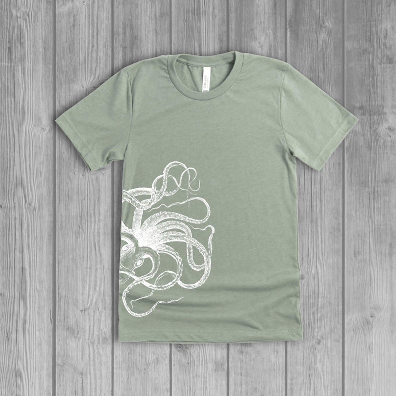 A dusty light sage green women's short-sleeve t-shirt with a white side octopus with tentacles print on the front.