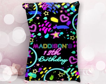 May include: Black party favor bag with a neon pink, blue, yellow, and green design. The bag has a neon pink heart, stars, and circles. The text "MADDISON'S 12th Birthday" is in neon pink and green.