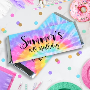 May include: A colorful tie-dye patterned chocolate bar wrapper with the text "Summer's 10th Birthday" in black script.