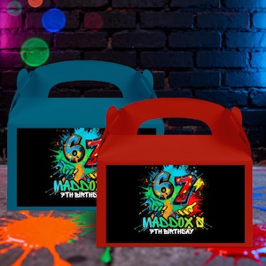 May include: Two colorful party favor boxes, one teal and one red, with handles. Each box features a black rectangle with a graffiti-style design that includes the number "67", the name "Maddox", and "7th Birthday".