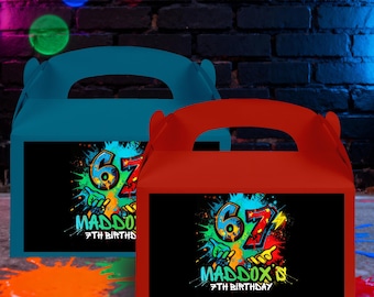 May include: Two colorful party favor boxes, one teal and one red, with handles. Each box features a black rectangle with a graffiti-style design that includes the number "67", the name "Maddox", and "7th Birthday".