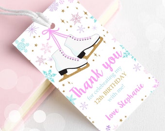 May include: White thank you tag with pink and blue snowflakes and gold glitter. The tag features a pair of white ice skates with pink laces and a pink ribbon. The text on the tag reads "Thank you for celebrating my 12th birthday with me! Love Stephanie."