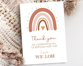 May include: A thank you card with a rainbow design in shades of pink, brown, and orange. The rainbow has a small heart in the center. The card says "Thank you for celebrating my 1st Birthday with me! Love Willoh".
