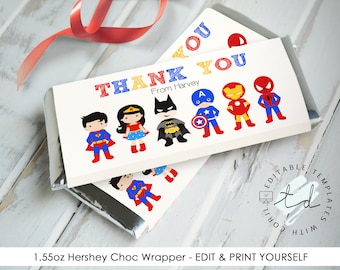 May include: Printable 1.55 oz Hershey chocolate bar wrapper featuring a superhero theme. The wrapper is white with a red, blue, and yellow "Thank You" message. It includes illustrations of Superman, Wonder Woman, Batman, Captain America, Iron Man, and Spiderman. The text "From Harvey" is included below the "Thank You" message.