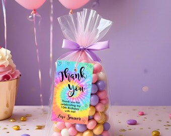 May include: A clear plastic bag filled with colorful candy, tied with a purple ribbon and a thank you tag. The tag has a tie-dye pattern and the text "Thank you" in black lettering. The text "Thank you for celebrating my 10th Birthday with me! Love Summer" is printed on the tag.