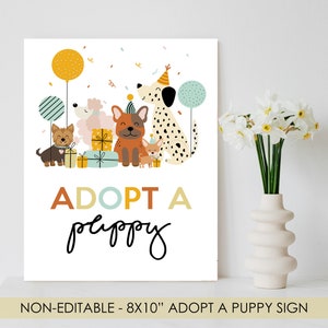 May include: A white sign with a colorful illustration of five dogs wearing party hats and holding presents. The text "ADOPT A puppy" is written in a colorful font below the illustration. The sign is 8x10 inches and is non-editable.