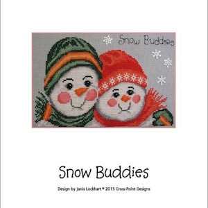 May include: Cross-stitch pattern featuring two snowmen wearing hats and scarves. The pattern is titled "Snow Buddies" and is designed by Janis Lockhart. The stitch count is 120 wide by 79 high.