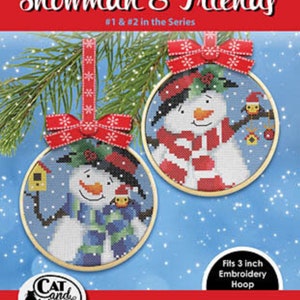 May include: Two cross-stitch embroidery hoops with snowman designs. The hoops are round, with wooden frames and red bows for hanging. The text "Snowman & Friends" is at the top. The design fits a 7.6 cm embroidery hoop.