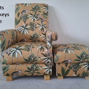 May include: An armchair and footstool set with a tan fabric featuring a monkey and palm tree design. The text "Fryetts Monkeys Ochre" is visible. The chair and footstool have wooden legs. The set would suit a living room.