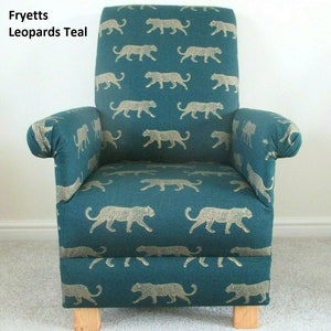 May include: Teal armchair featuring a repeating pattern of tan leopards. The chair has a high back, rolled arms, and wooden legs. The text "Fryetts Leopards Teal" is visible on the top left.