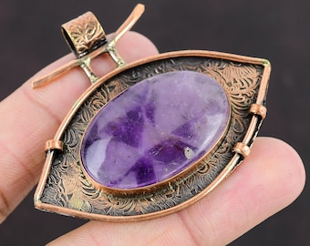 May include: A copper pendant with an ornate design and a large oval amethyst gemstone in the center.