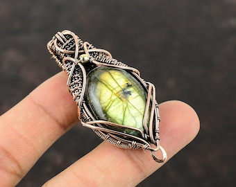 May include: A green labradorite gemstone pendant wrapped in copper wire with a gold accent.