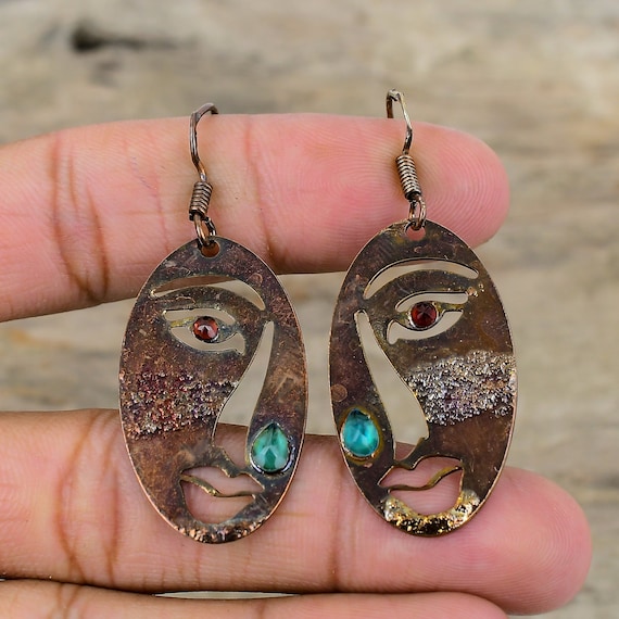 Electroformed copper wraps raw chrome diopside and Mozambique garnet in a process that grows metal crystal by crystal — wearable geology you can't find at a mall.