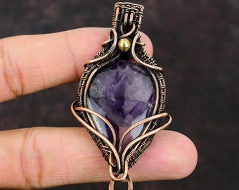 May include: A purple amethyst gemstone pendant wrapped in copper wire with a gold accent bead.