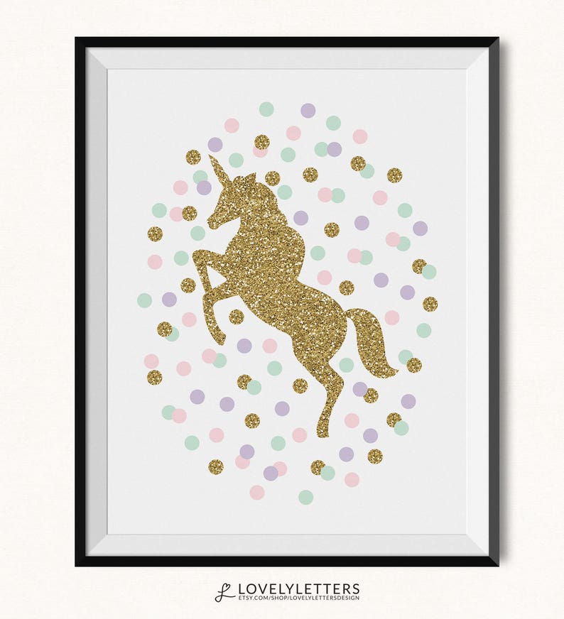 May include: A framed print featuring a gold glitter unicorn rearing up, surrounded by pastel confetti dots in pink, purple, and mint green. The print is on a white background and has a black frame. The Etsy shop name "LOVELYLETTERS" is at the bottom.