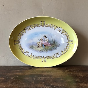 Hand Decorated Oval Platter With Yellow Border, Cupid And Psyche, Signed Theobald, LM & C Montereu, France, Late 19th Century