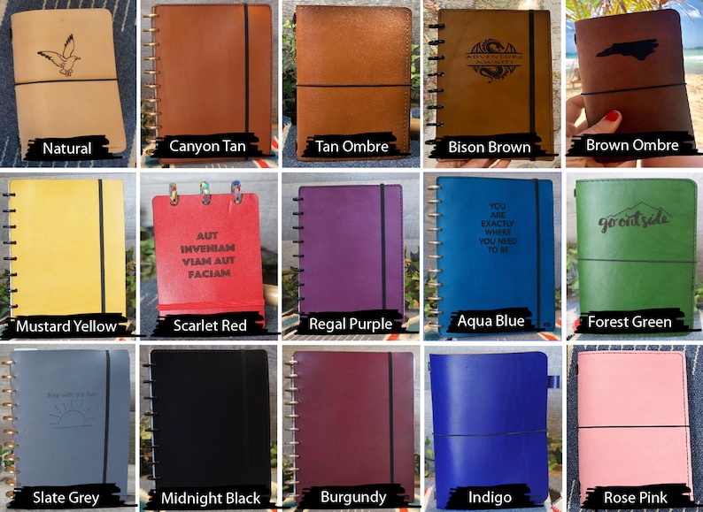 May include: A collection of 15 different colored leather-bound journals with various designs and text. The journals have a spiral binding and a black elastic band.