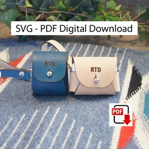 May include: Two leather Airpod cases with a snap closure. The cases are blue and beige and have the initials "RTD" engraved on the front. The image also includes a PDF download icon.