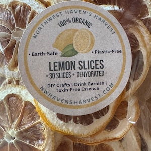 May include: A clear plastic bag filled with dehydrated lemon slices. A circular label reads: Northwest Haven's Harvest, 100% Organic, Earth-Safe, Plastic-Free, Lemon Slices, 30 Slices, Dehydrated, DIY Crafts, Drink Garnish, Toxin-Free Essence, NWHAVENSHARVEST.COM.