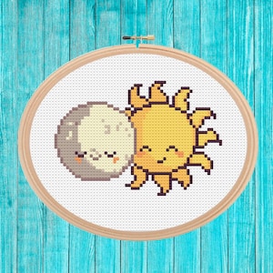 May include: A cross-stitch embroidery design featuring a yellow sun and a gray moon with smiling faces, both with closed eyes, as if they are hugging.