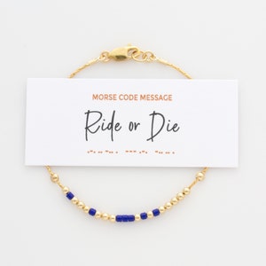 May include: Gold beaded bracelet with blue beads spelling out the Morse code message "Ride or Die".
