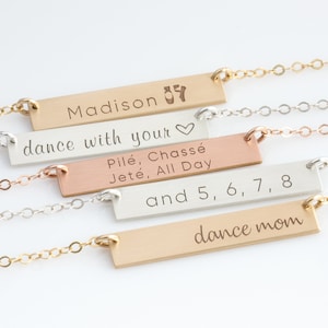 May include: Four gold bar necklaces with different engraved messages. The top necklace says "Madison 🩰 dance with your ♥". The second necklace says "Pilé, Chassé Jeté, All Day". The third necklace says "and 5, 6, 7, 8". The bottom necklace says "dance mom".