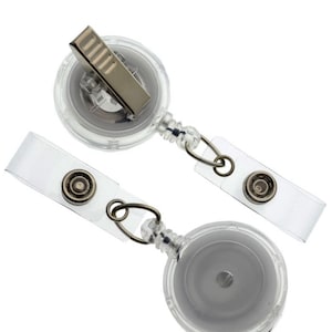 May include: Two clear retractable badge reels with a silver clip and a clear plastic badge holder.