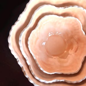 May include: A white ceramic mug with a black handle and the text "But First, Coffee" in a black, bold font. The mug is sitting on a white surface. The mug is approximately 4 inches tall.