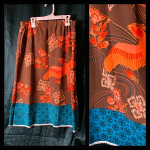 May include: A brown skirt with a blue and white floral print. The skirt has a ruffled hem and a waistband.