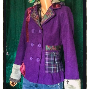 May include: A purple double-breasted jacket with a patchwork design. The jacket has a hood, a velvet collar, and a plaid pocket on the front. The sleeves have a gray and white knit cuff.