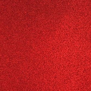 Peut inclure: Un gros plan sur une feuille de papier rouge paillet&eacute;. Le papier a une texture fine et uniforme et une finition brillante.