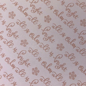 May include: A white background with a repeating pattern of the phrase "all is calm all is bright" in a cursive font. The phrase is printed in a light brown colour. Small snowflake designs are scattered throughout the background.