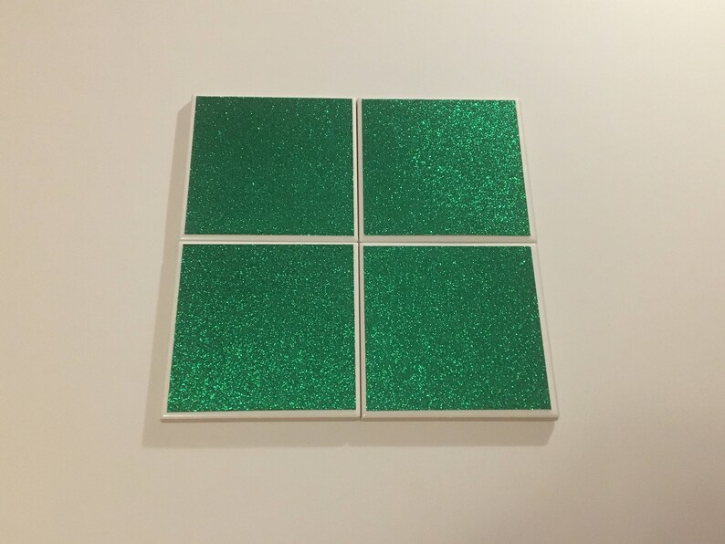 May include: Four square green glitter tiles with white borders.